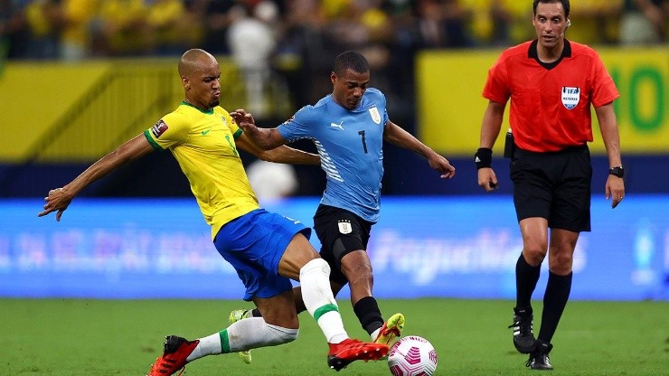 De La Cruz ante la marca de Fabinho en el último Uruguay vs. Brasil por Eliminatorias.